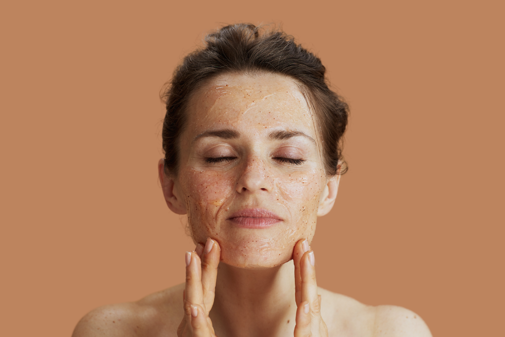 Woman exfoliating face.