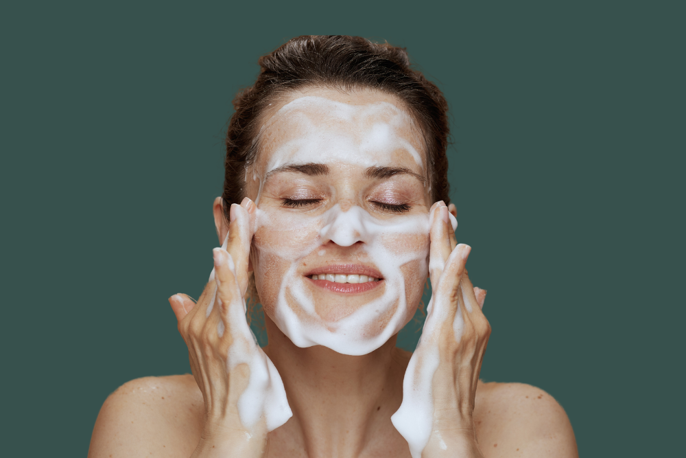 Woman gently cleansing face.