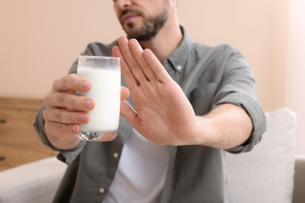 Person trying to reduce eczema symptoms by avoiding dairy products.