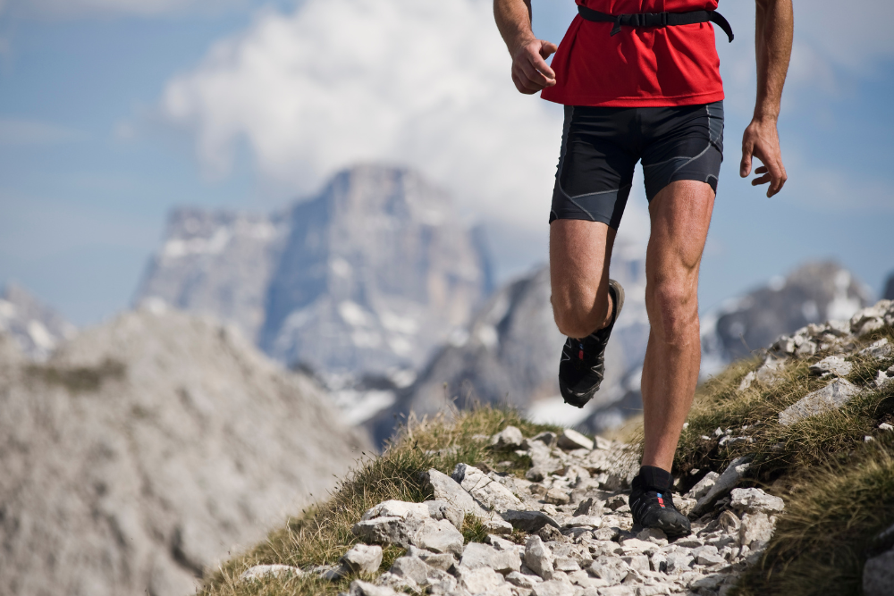 A man trail running with improved cardiovascular health.