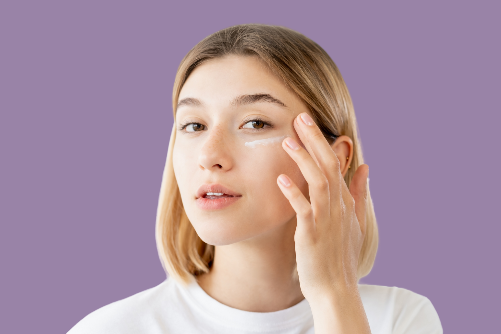 Young female applying moisturiser