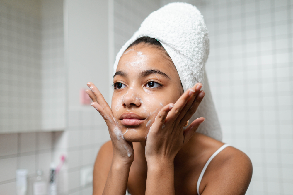 Young girl cleansing her skin