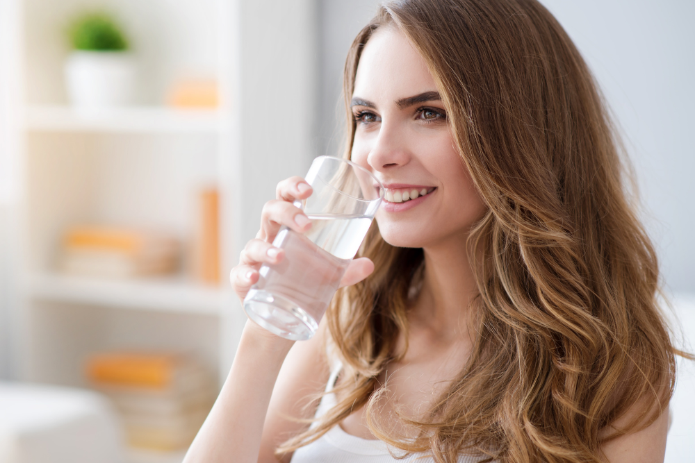 A woman staying hydrated to prevent urinary tract infections.