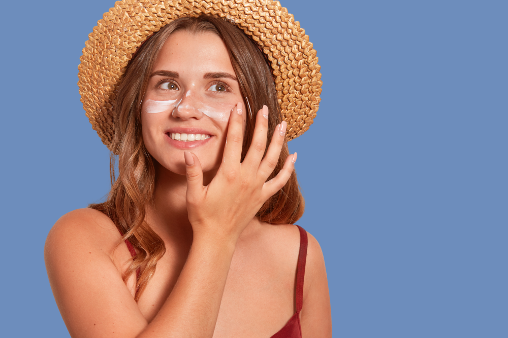 Woman with hat and sunscreen for skin protection.