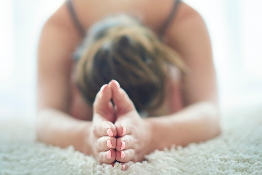 Woman managing stress with yoga.